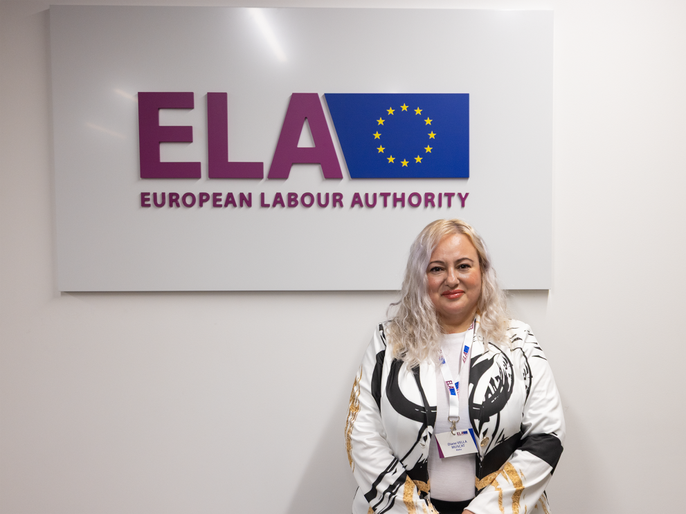Woman with blond hair standing in front of ELA sign