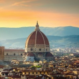 Panoramic view of Florence at sunset, featuring the iconic Duomo and city skyline.