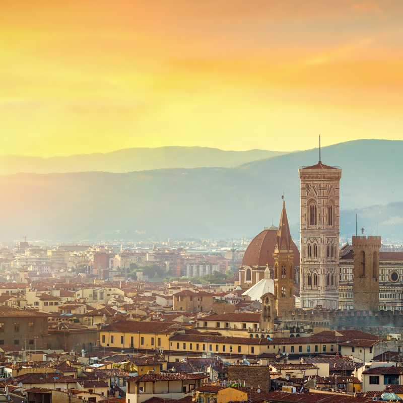 Panoramic view of Florence at sunset, featuring the iconic Duomo and city skyline.
